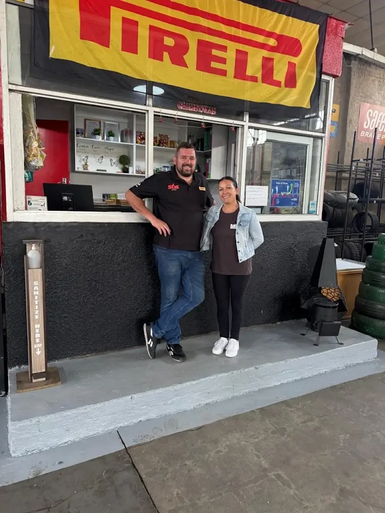 Stoffel and Laura standing in front of the Pirelli-branded counter at Tyre Salvage